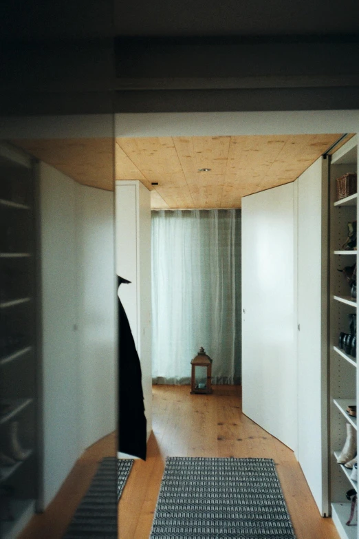an empty hallway with white walls and wooden floors