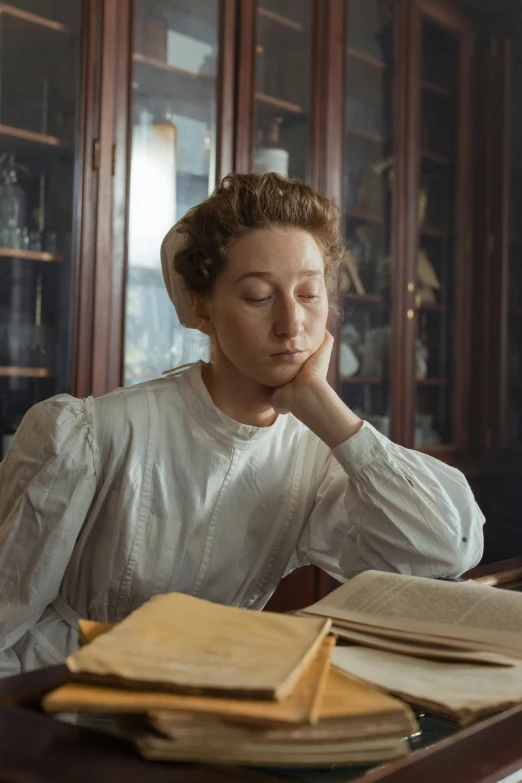 a woman reading from a book and looking up at it