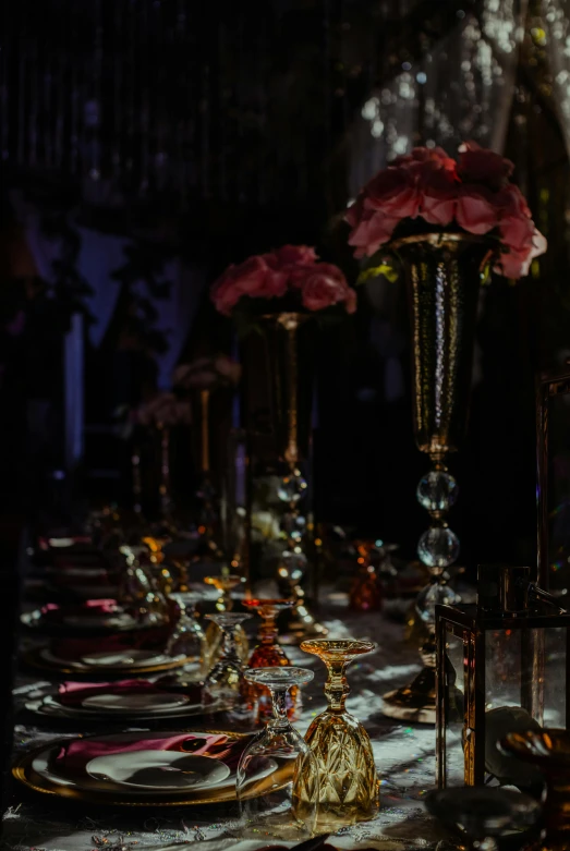 a bunch of goldware and red flowers are on a table