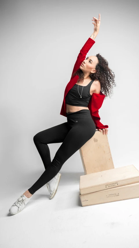 a woman standing on top of a wooden box