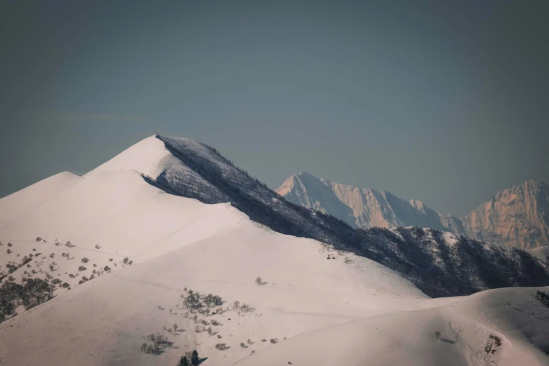 a group of mountains that are covered with snow