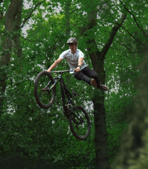 a man flying through the air while riding a bike