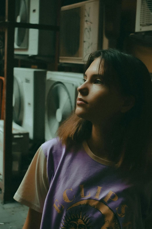 a young woman standing next to stacked washer machines