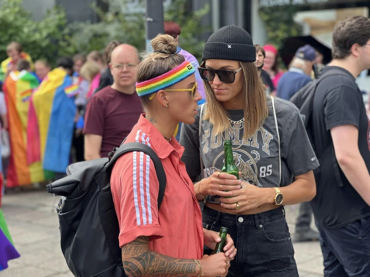 a man talking to a woman near a crowd