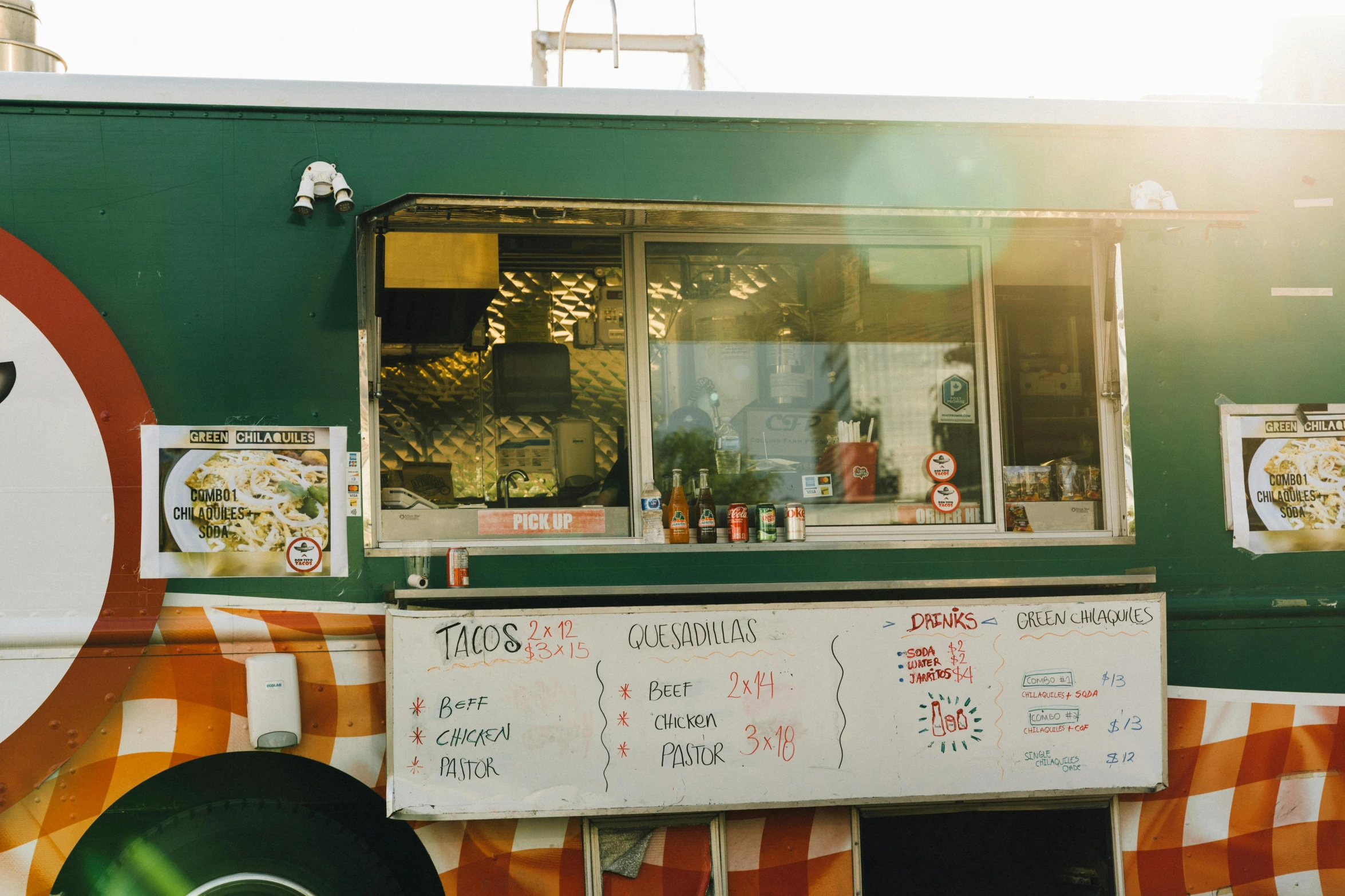 a fast food truck is shown with a sign in front