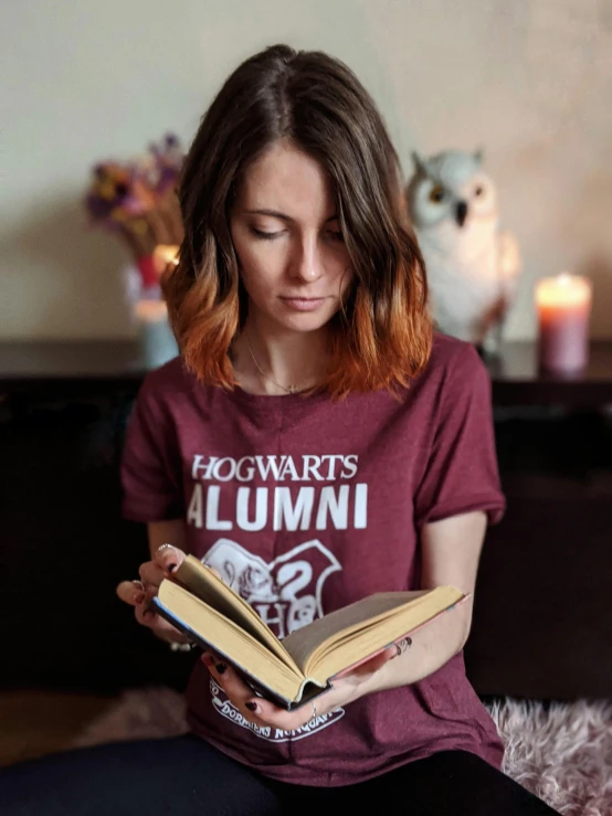 young woman reading harry potter book in living room