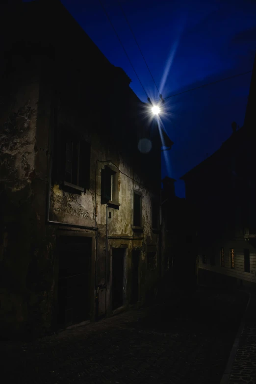 a dark and creepy old building in the middle of the street