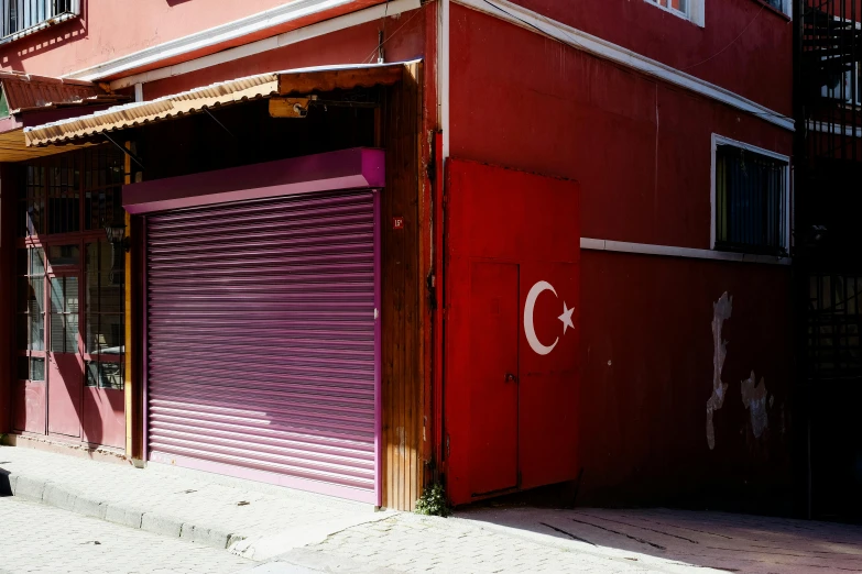 red garage door and shutters on the side of a building