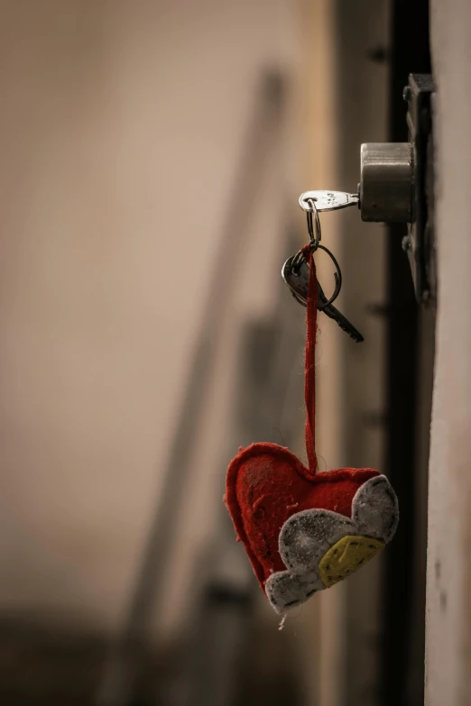 a heart shaped key chain hanging from the handle