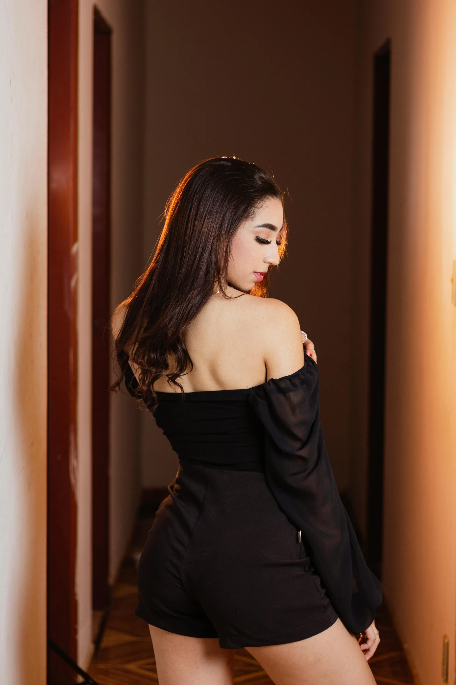a girl posing in a black dress