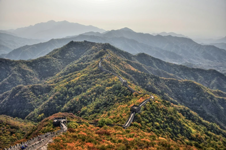 a view from above of a mountain with a winding road between mountains