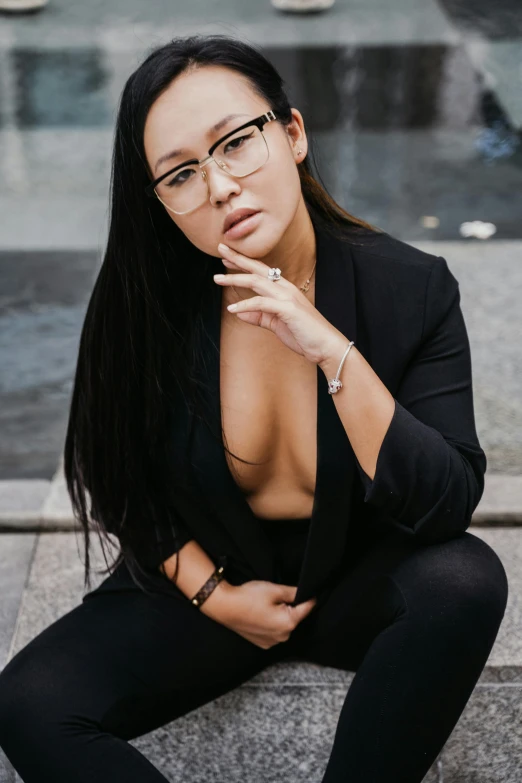 a women in glasses sitting on a step smoking