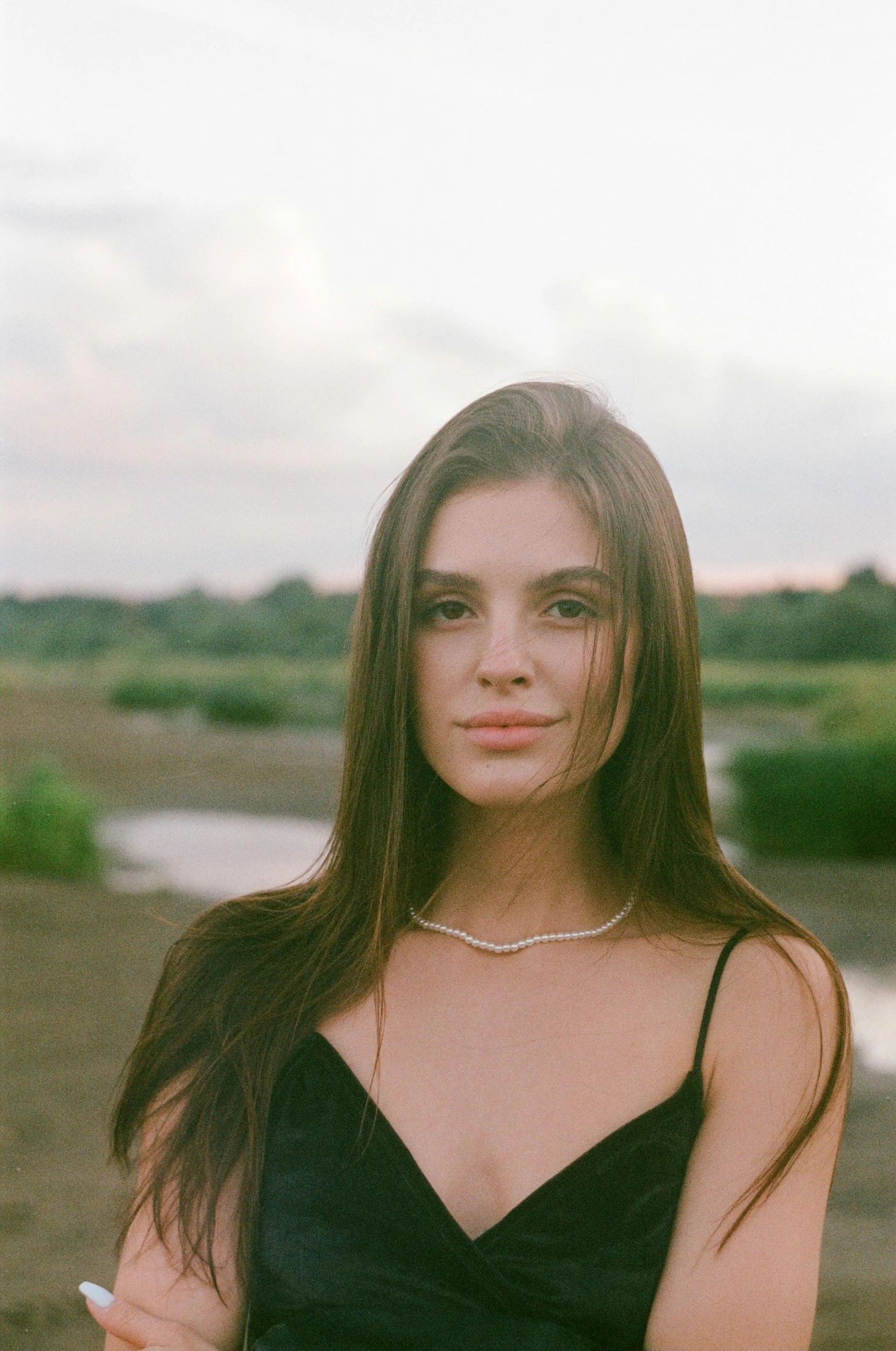 a beautiful woman with long brown hair holding soing in her hand