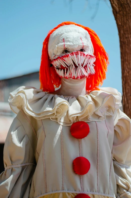 a scary clown wearing white and orange wigs
