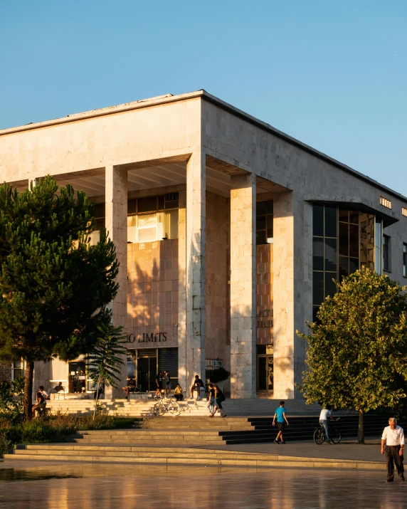 a few people walking in front of a building