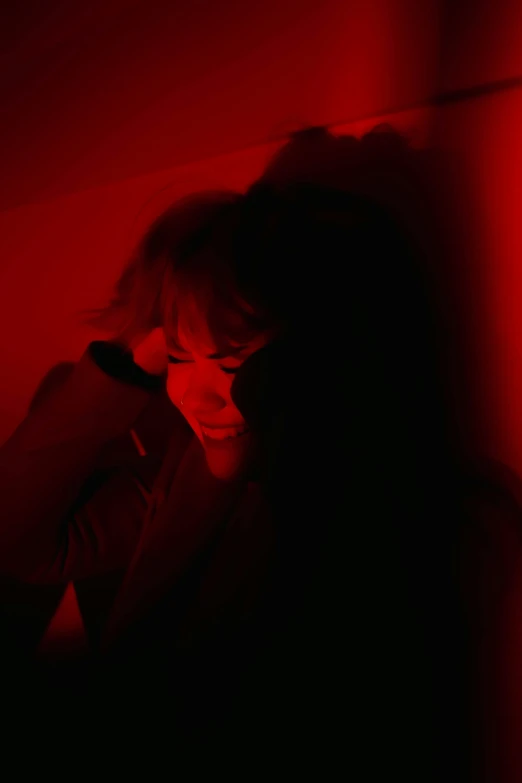 a person in the dark with a red background