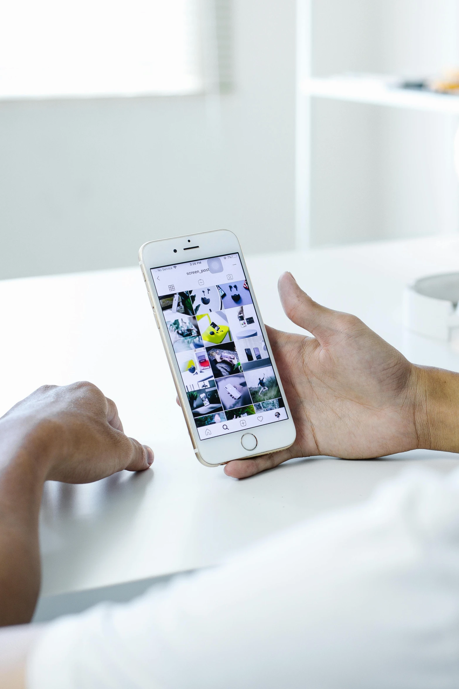 a man is using an iphone on his desk