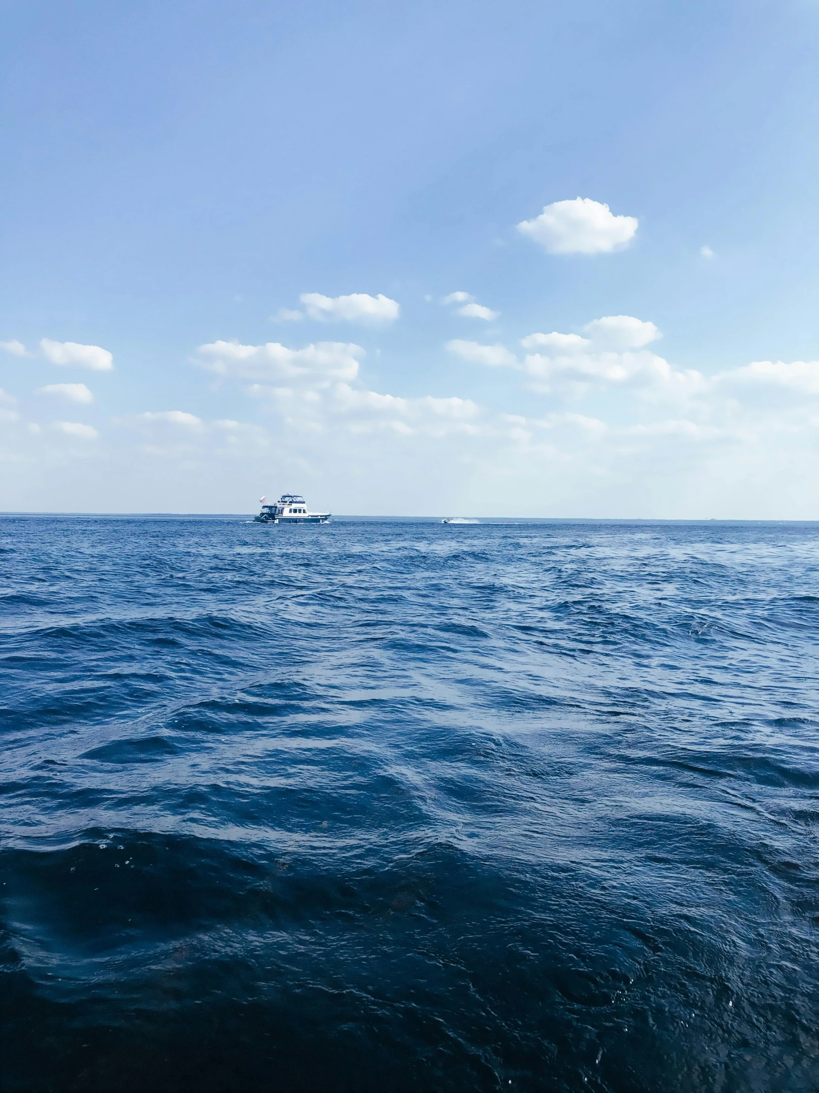 an ocean view with a boat out on the horizon