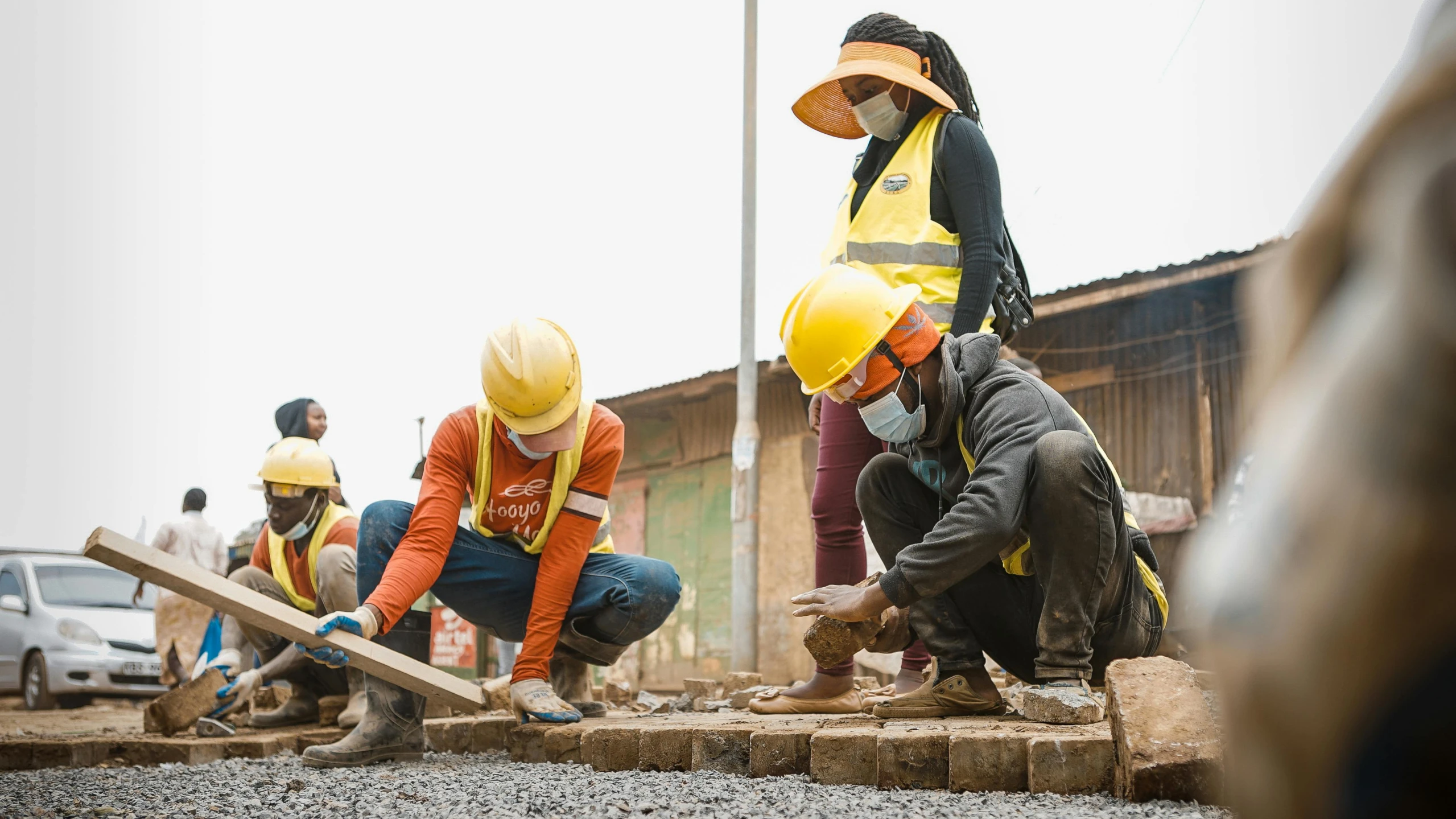 a group of construction workers work on a building