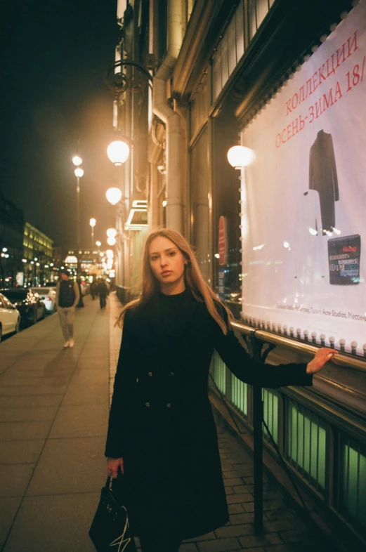 a beautiful young lady leaning on a glass window