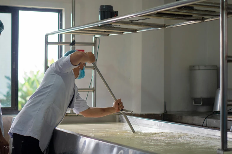 man cleaning white soapy waters on machine