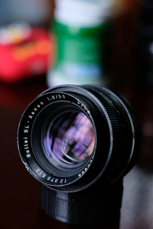 the back view of an old camera with a lens attached