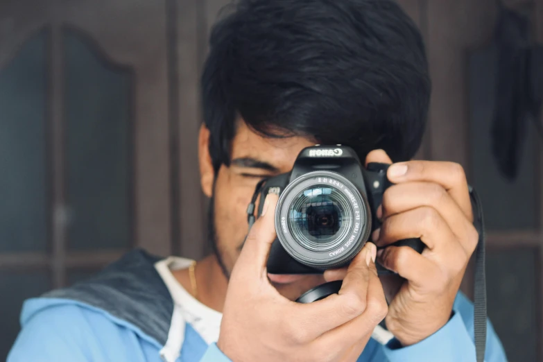 a man holding up a camera to take a picture