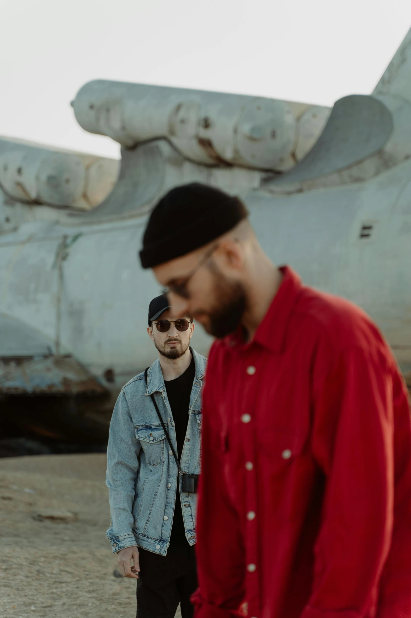 two people standing in front of a plane