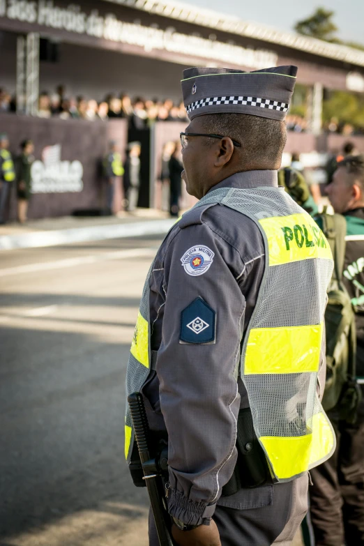 a policeman watches as people stand in line