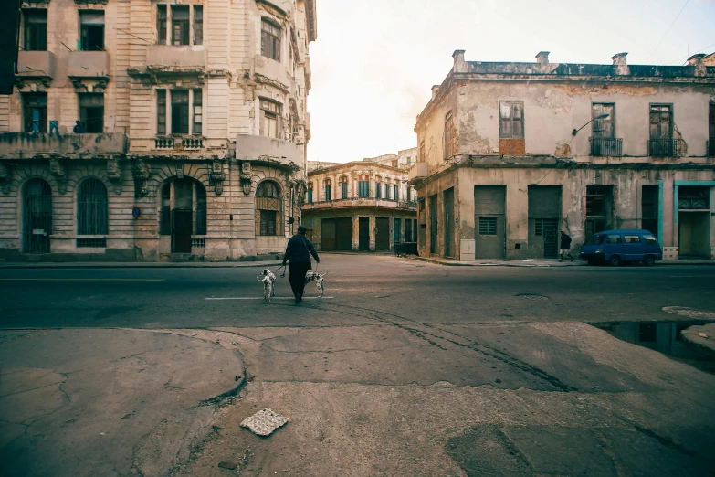 two people riding bicycles down a deserted street