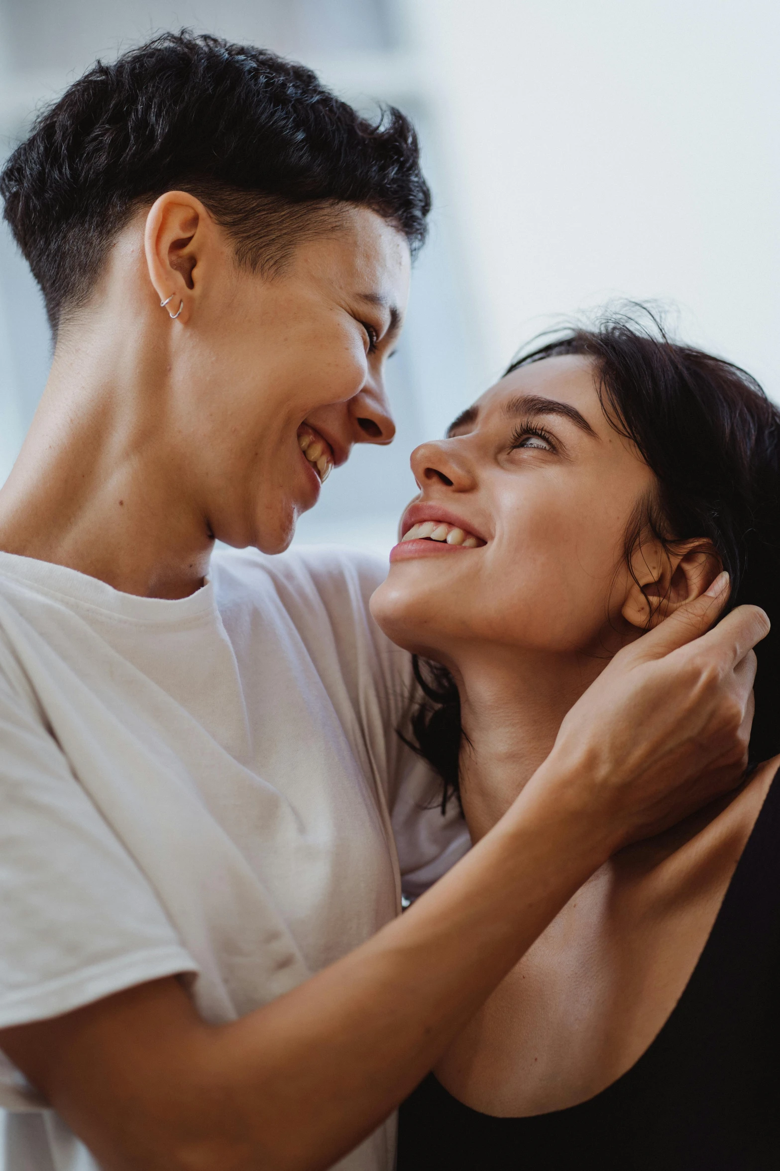 two people standing next to each other and smiling