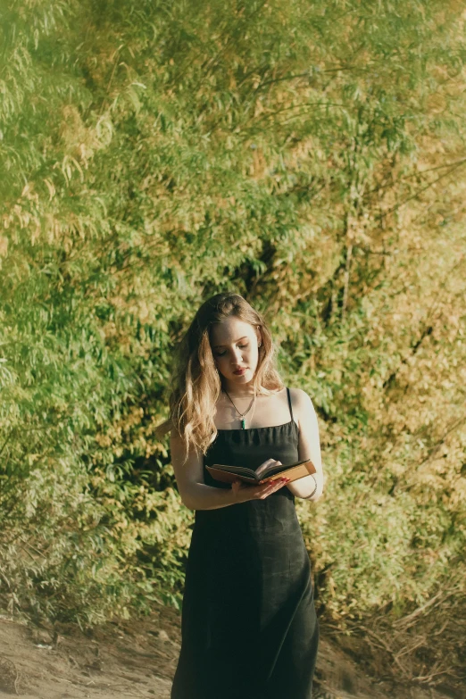 a woman standing in front of tall grass