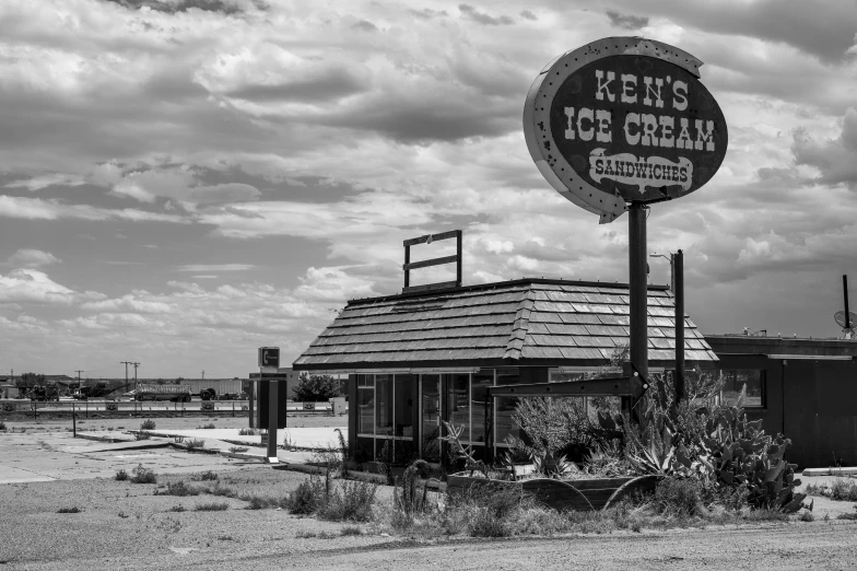 an old sign and building in the desert