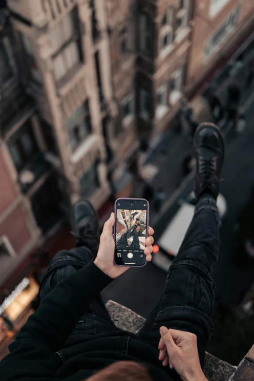 woman taking selfie from ledge above looking down