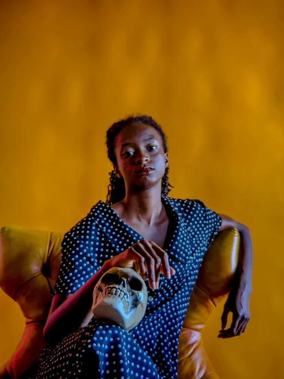 a woman in an animal print blouse holds up a small toy