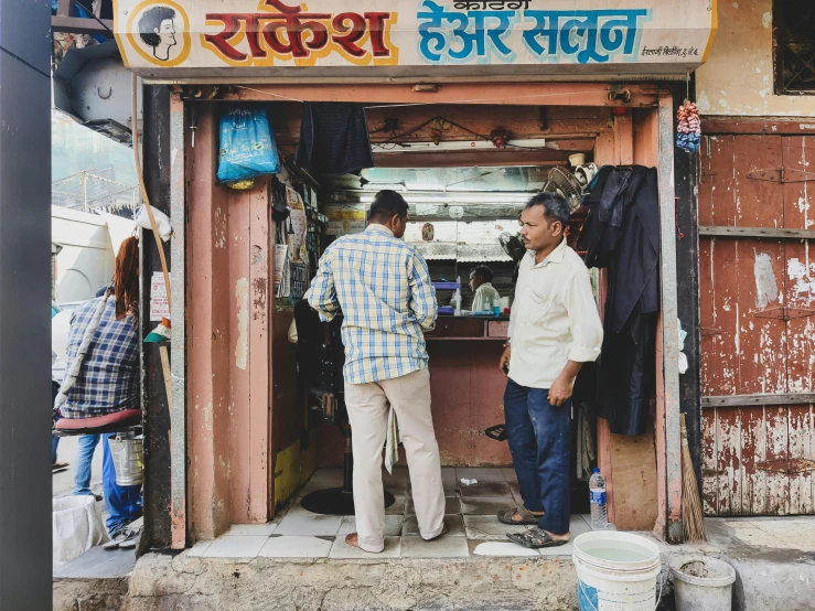 two men talking to each other in an open door