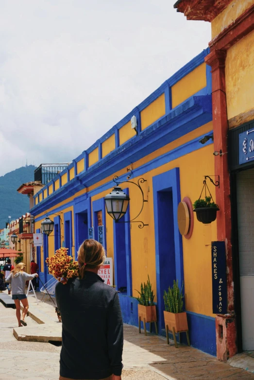 a group of people walking down the street by buildings