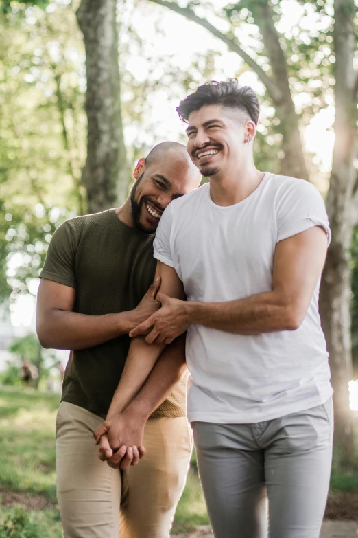 an affectionate couple walking in the park while laughing