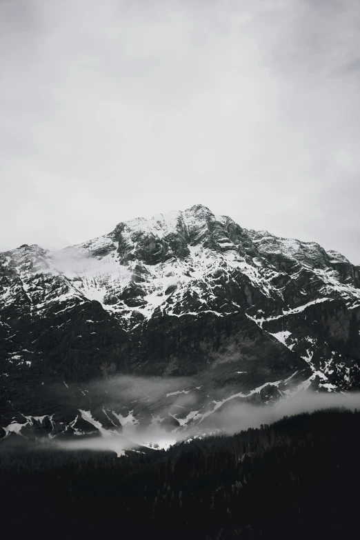 the top of a mountain with snow capped tops