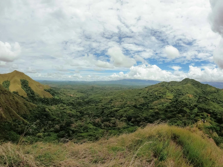 a view of some green hills and blue sky