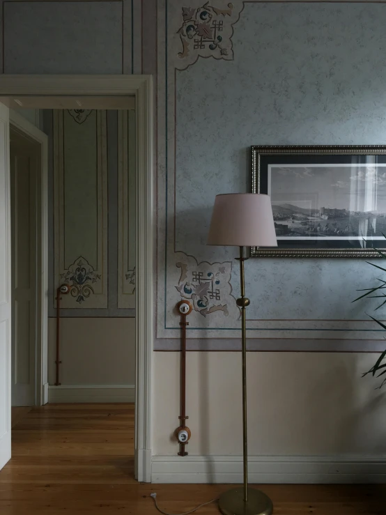 a lamp and vase are in a corner of a room