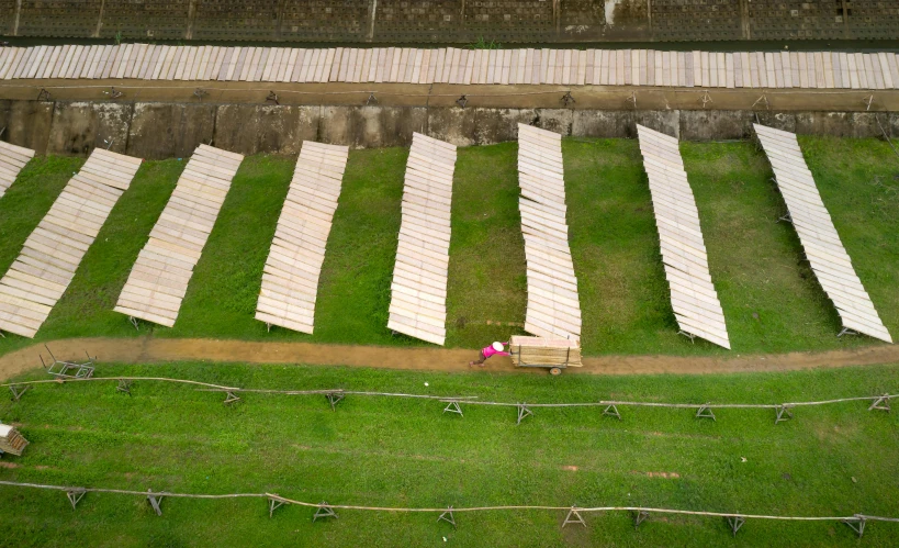 some big wooden chairs laying down in the grass