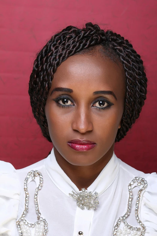 a woman in a white blouse with ids wearing a bow tie