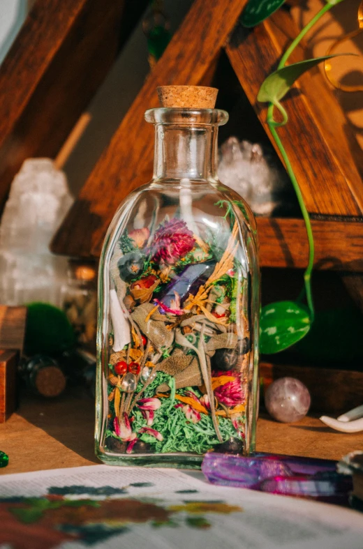 a glass bottle with various types of flower seeds inside