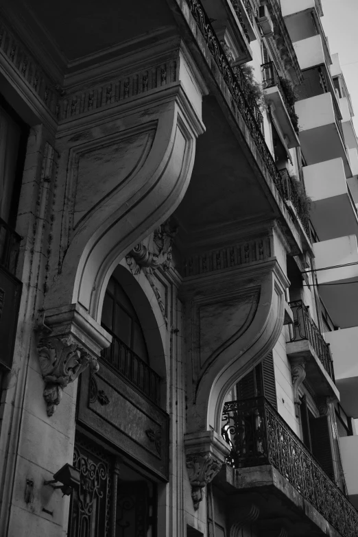 an ornate building with balconies on the upper and lower levels