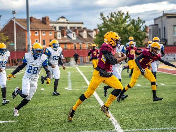 a football game with a player running after the ball