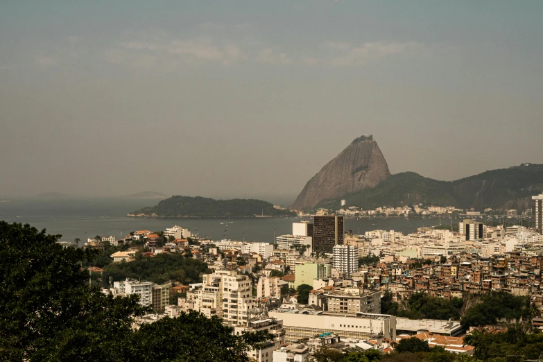 a city with mountains in the background and ocean in the foreground