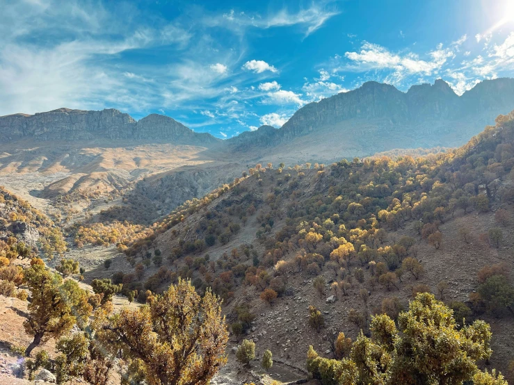 the mountains are covered with green vegetation as a sun shines in