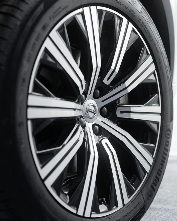 the front wheels of a car with black and white spokes