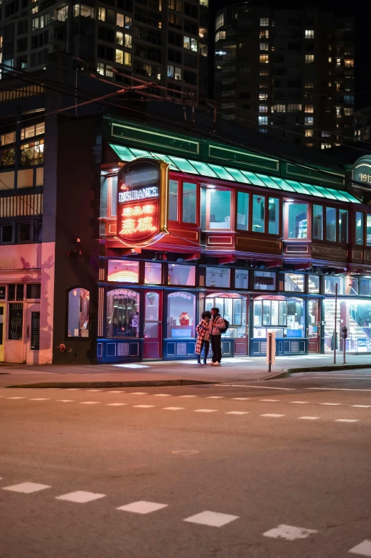 a tall colorful building in the middle of a city